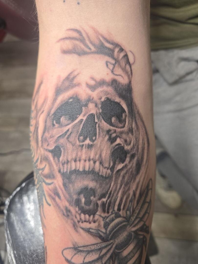 Blackwork skull tattoo on an arm